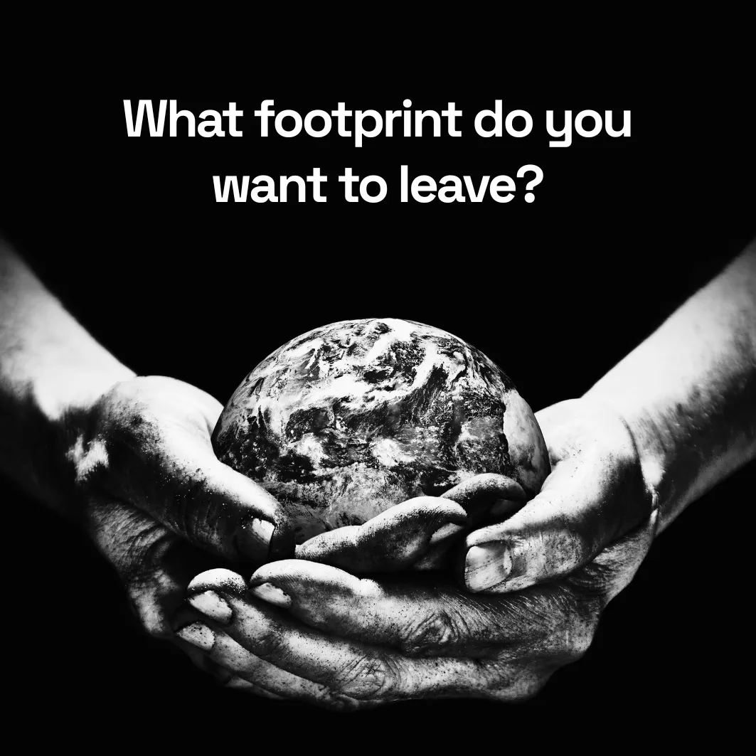 Soiled hands holding a gray lifeless Earth