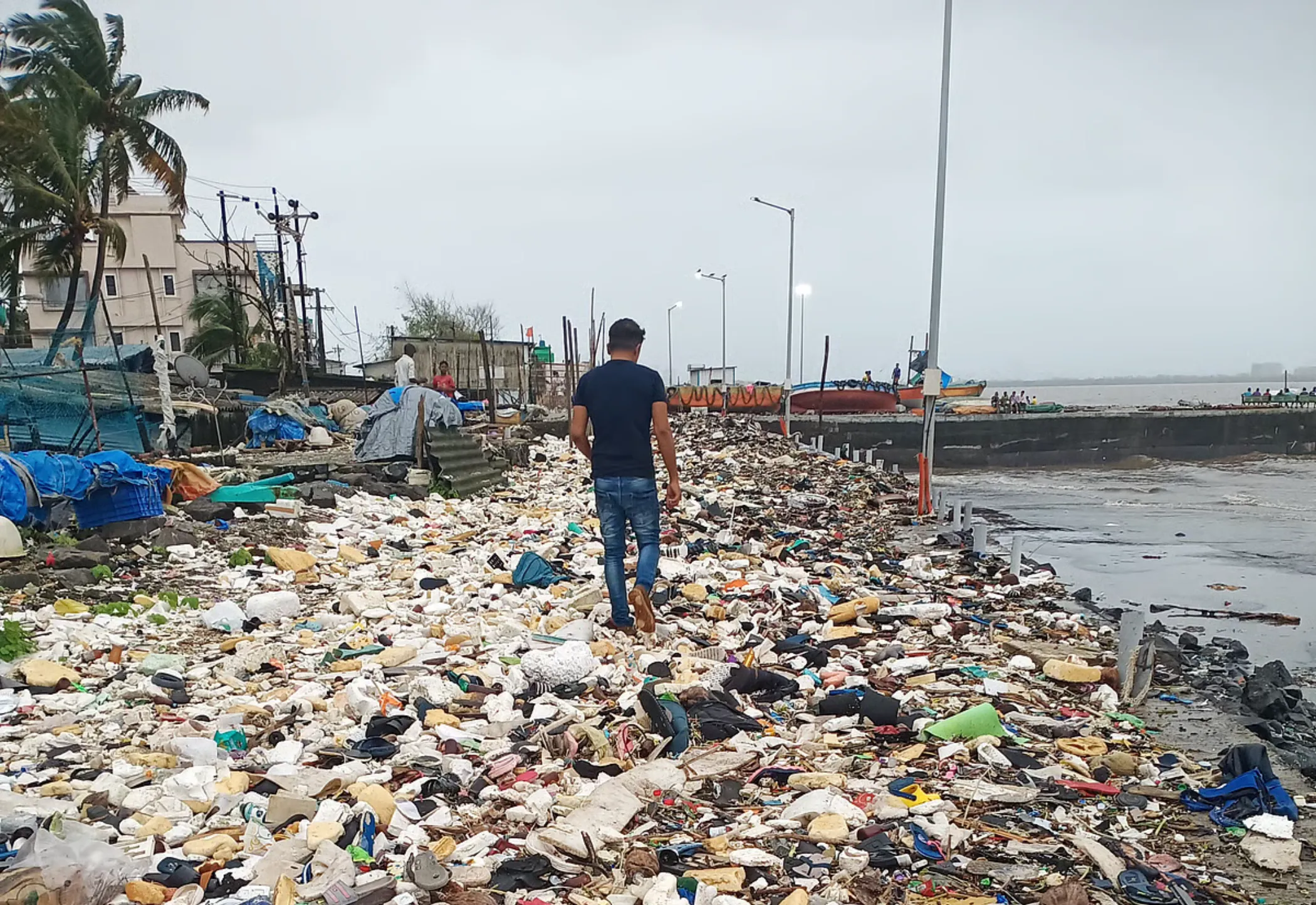 Shoreline covered in plastic waste before the Eyesea cleanup